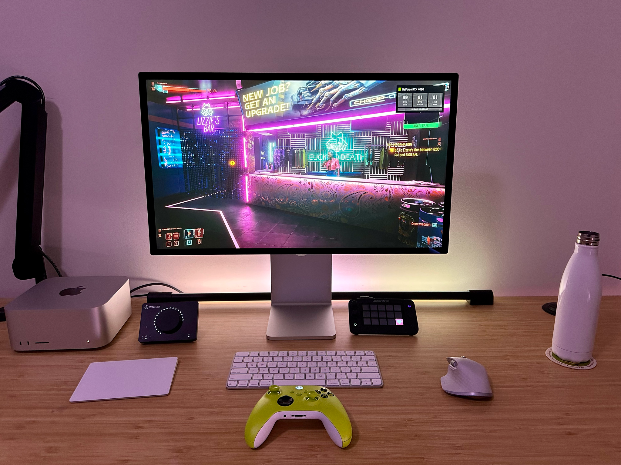 A desk setup with a Mac Studio running Cyberpunk 2077.